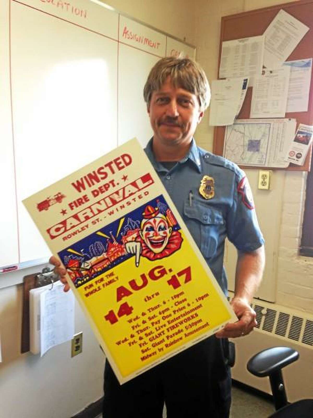 Capt. James Lagassie holds a flier for the Winsted Fire Department's upcoming carnival. (Mercy Quaye-Register Citizen)