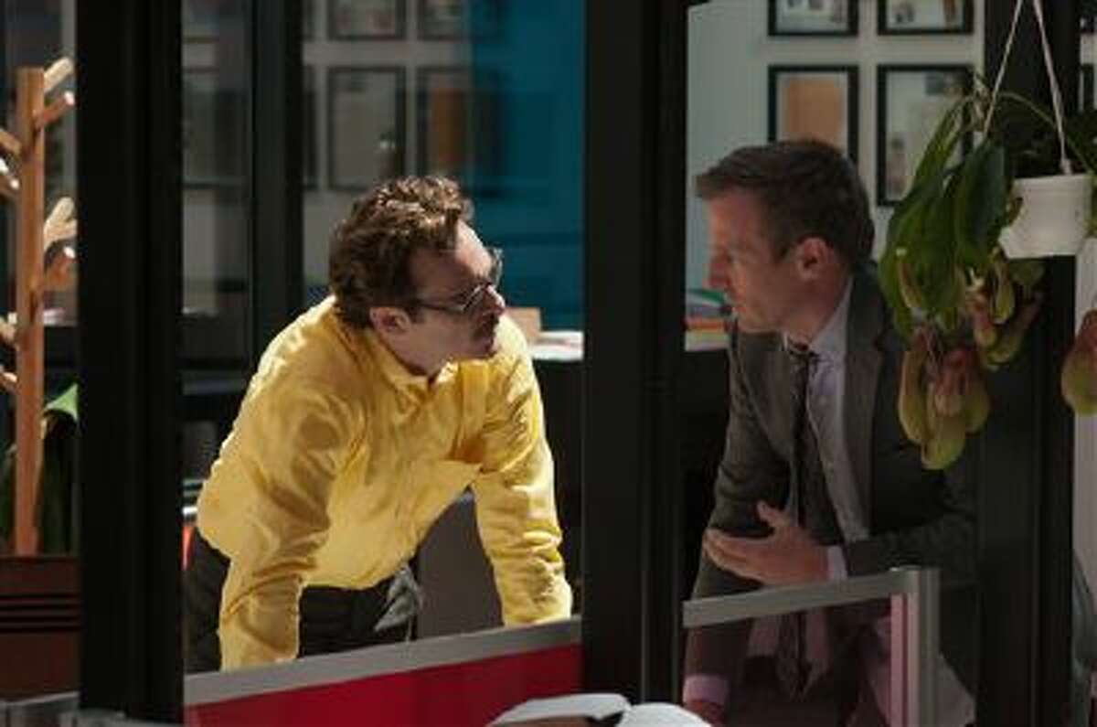This image released by Warner Bros. Pictures shows Joaquin Phoenix, left, and director Spike Jonze on the set of "Her." The film has been selected as the best film of the year by the National Board of Review and Phoenix was nominated for a Golden Globe for best actor in a motion picture musical or comedy.