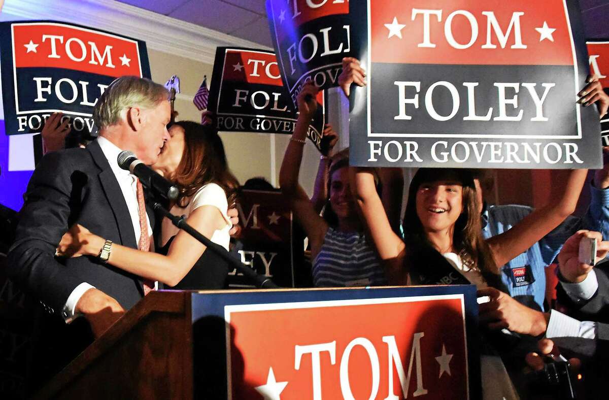 Republican gubernatorial candidate Tom Foley kisses his wife, Leslie, to cheers of supporters at the Villa Rosa Pontelandolfo Club in Waterbury Tuesday night after winning the Republican primary.