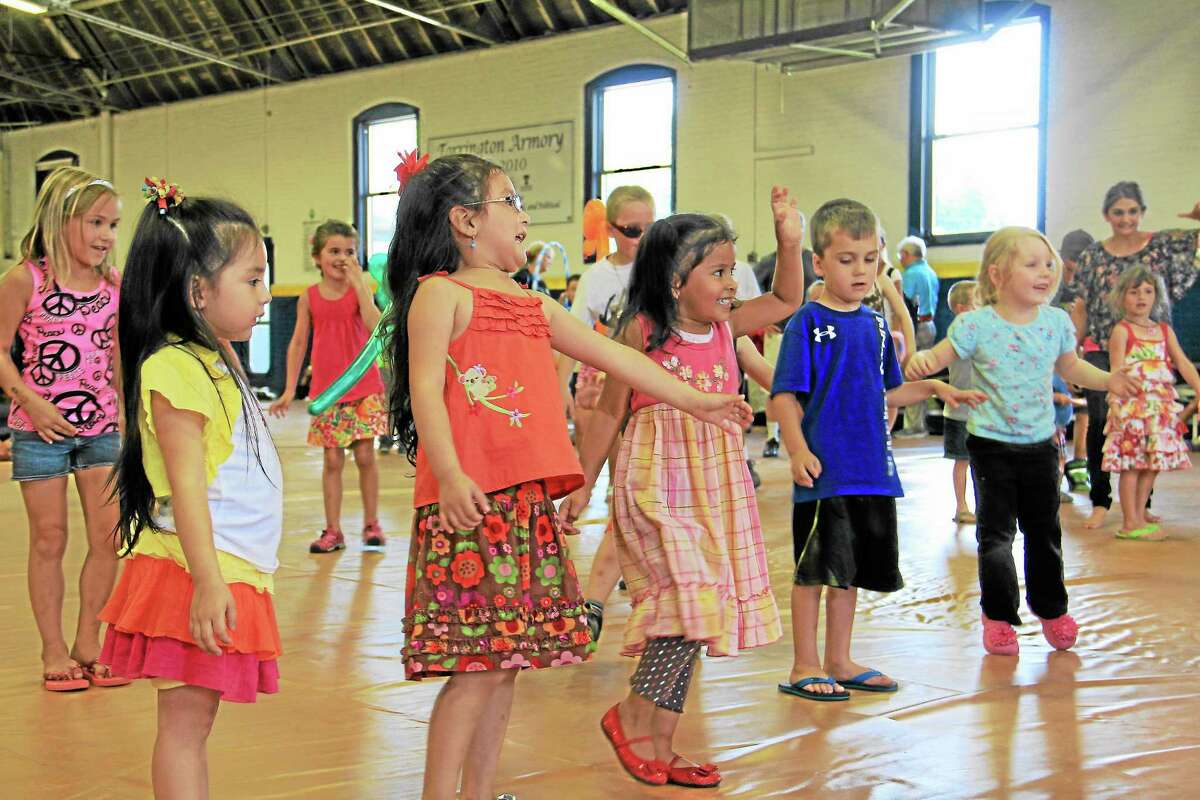 Children dance during an end of the summer reading party organized by the Torrington Public Library at the city’s armory on Monday, August 12. The party was a reward for all the children who participated in the library’s summer reading program.
