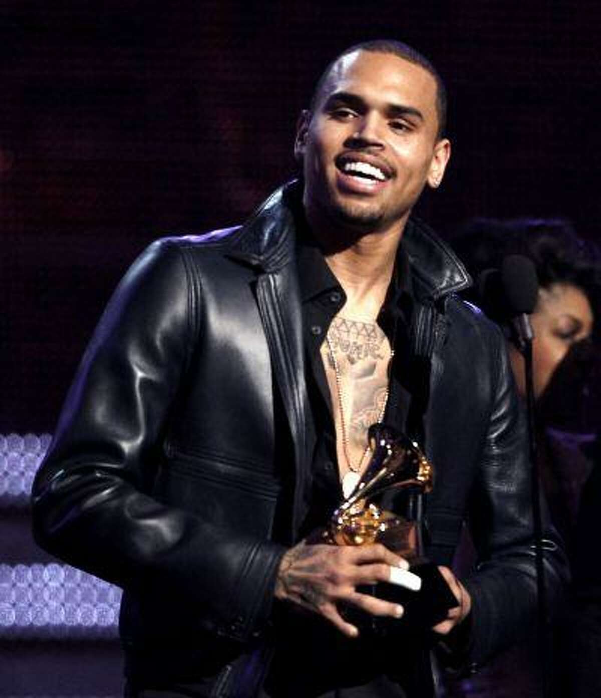 In this Feb. 12, 2012 file photo, Chris Brown accepts the award for best R&B album for "F.A.M.E." during the 54th annual Grammy Awards in Los Angeles.