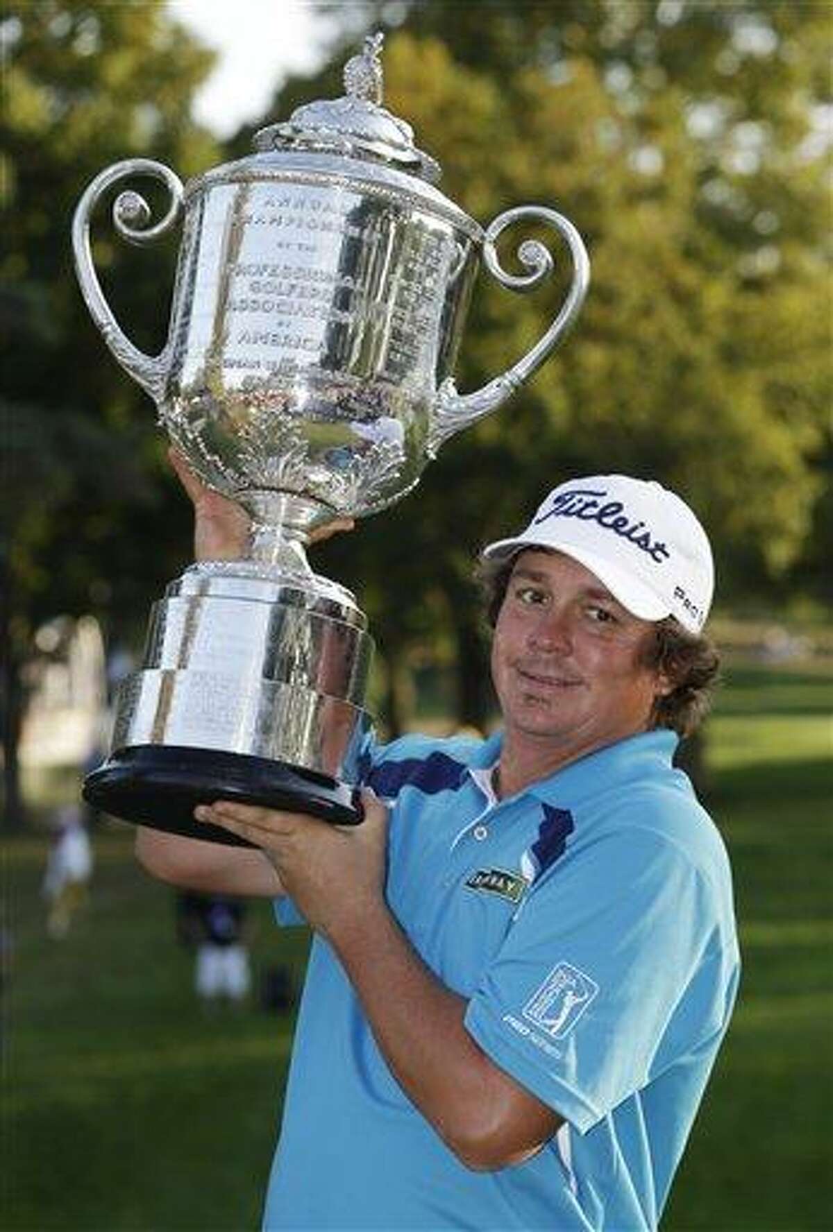 Jason Dufner holds up the Wanamaker Trophy after winning the PGA Championship golf tournament at Oak Hill Country Club, Sunday, Aug. 11, 2013, in Pittsford, N.Y. (AP Photo/Julio Cortez)