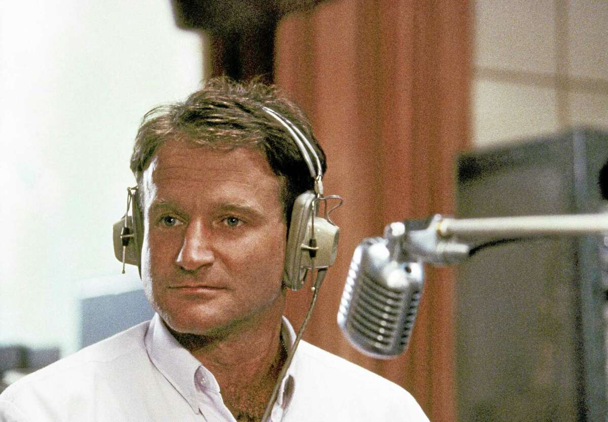 FILE - This 1987 file photo released by Touchstone Pictures shows actor Robin Williams in character as disc-jockey Adrian Cronauer in director Barry Levinsons comedy drama, "Good Morning Vietnam." Williams, whose free-form comedy and adept impressions dazzled audiences for decades, has died in an apparent suicide. He was 63. The Marin County Sheriffís Office said Williams was pronounced dead at his home in California on Monday, Aug. 11, 2014. The sheriffís office said a preliminary investigation showed the cause of death to be a suicide due to asphyxia. (AP Photo/Touchstone Pictures)
