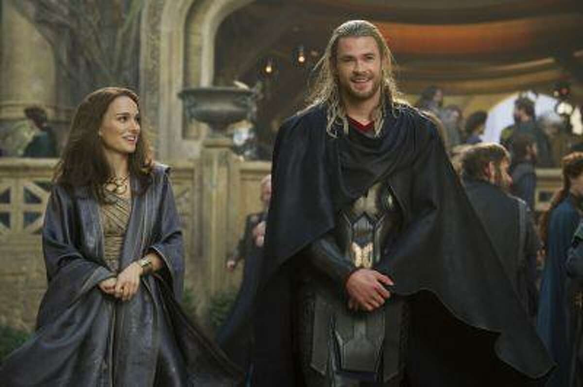 This publicity photo released by Walt Disney Studios and Marvel shows Natalie Portman, left, as Jane Foster and Chris Hemsworth as Thor, in Marvel's "Thor: The Dark World."