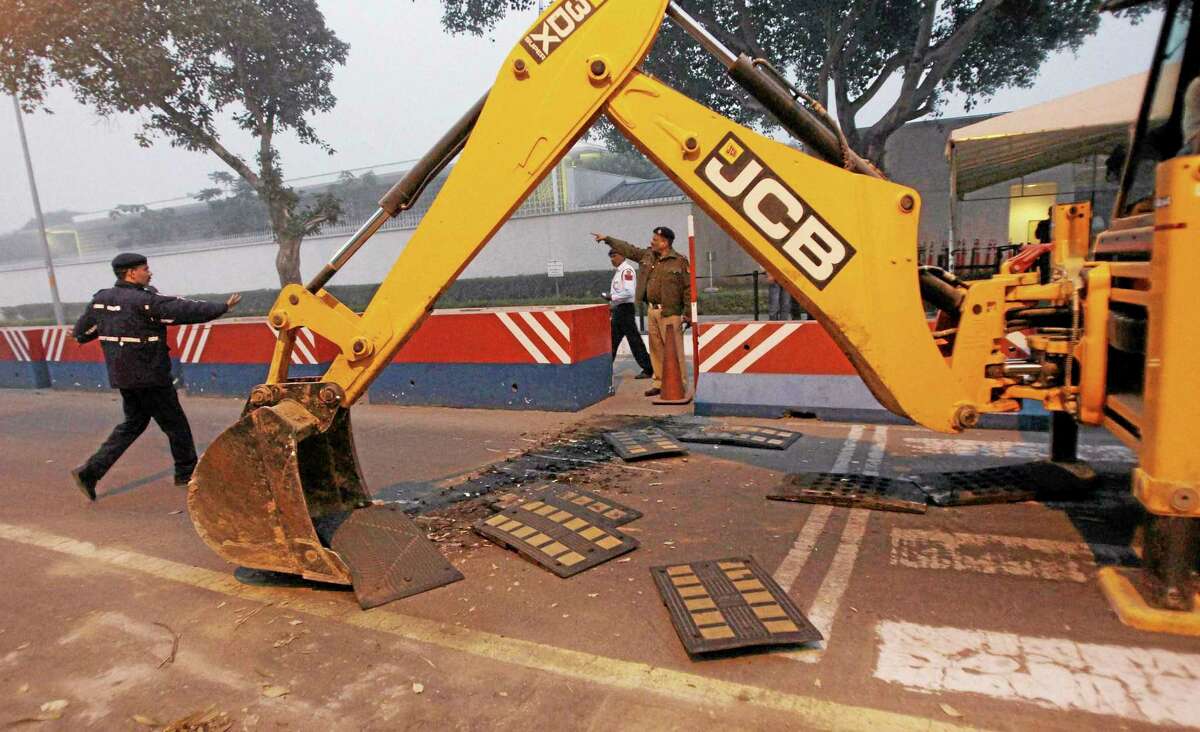 Indian police remove barricades that had been erected as a safety measure outside the main entrance of U.S Embassy, reportedly in retaliation to the alleged mistreatment of New York based Indian diplomat Devyani Khobragade, in New Delhi, India, Tuesday, Dec. 17, 2013. The arrest and strip search of the Indian diplomat escalated into a major diplomatic furor Tuesday as India's national security adviser called the woman's treatment "despicable and barbaric." (AP Photo) INDIA OUT