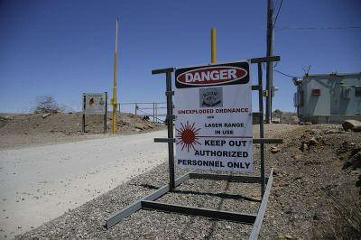 A sign warns visitors of the dangers involved when entering the seaside hills of San Clemente Island, where North America's rarest bird calls home Wednesday, July 17, 2013.