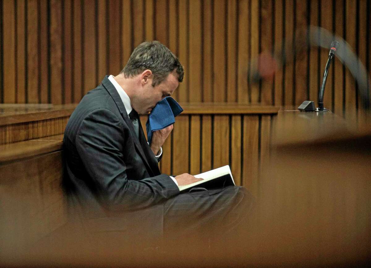 Oscar Pistorius reacts as he listens to the state prosecutor summarizing evidence at his murder trial in Pretoria, South Africa, Thursday, Aug. 7, 2014. The chief prosecutor said Thursday the double-amputee athlete's lawyers have floated more than one theory in a dishonest attempt to defend against a murder charge for his killing of girlfriend Reeva Steenkamp. (AP Photo/Mujahid Safodien, Pool)