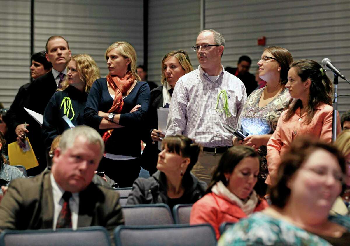 FILE--In this Oct. 24, 2013 file photo, people line up to speak at a Common Core learning reforms forum at the Stephen and Harriet Myers Middle School in Albany, N.Y. (AP Photo/Mike Groll, File)