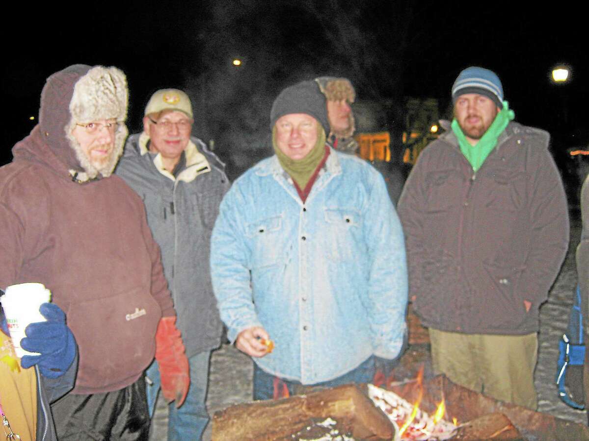 Town Manager Dale Martin, center, and others gather in Winsted’s East End Park on Dec. 13 for the YMCA’s second-annual “Freezin’ for a reason” event to raise awareness of the conditions faced by the homeless population.