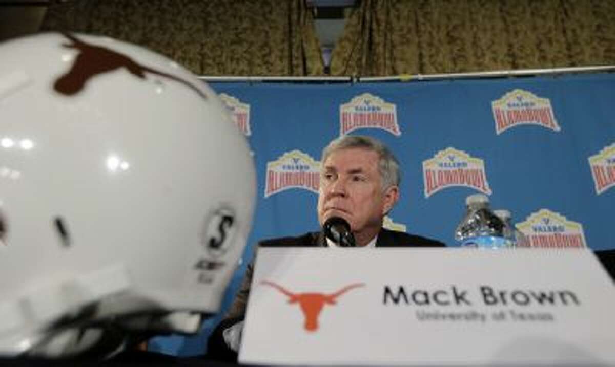 Texas coach Mack Brown listens to a question during a Valero Alamo Bowl NCAA college football news conference, Thursday, Dec. 12, 2013, in San Antonio. Texas.