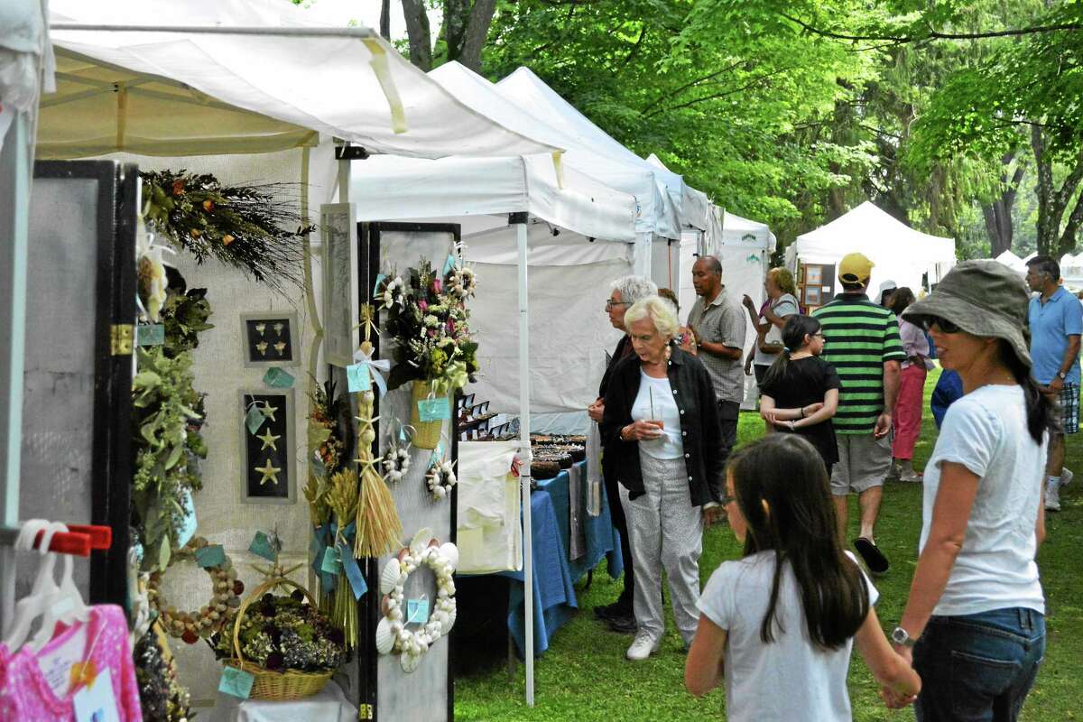 Locals survey the diverse goods at the 55th annual arts and crafts fair on the green.