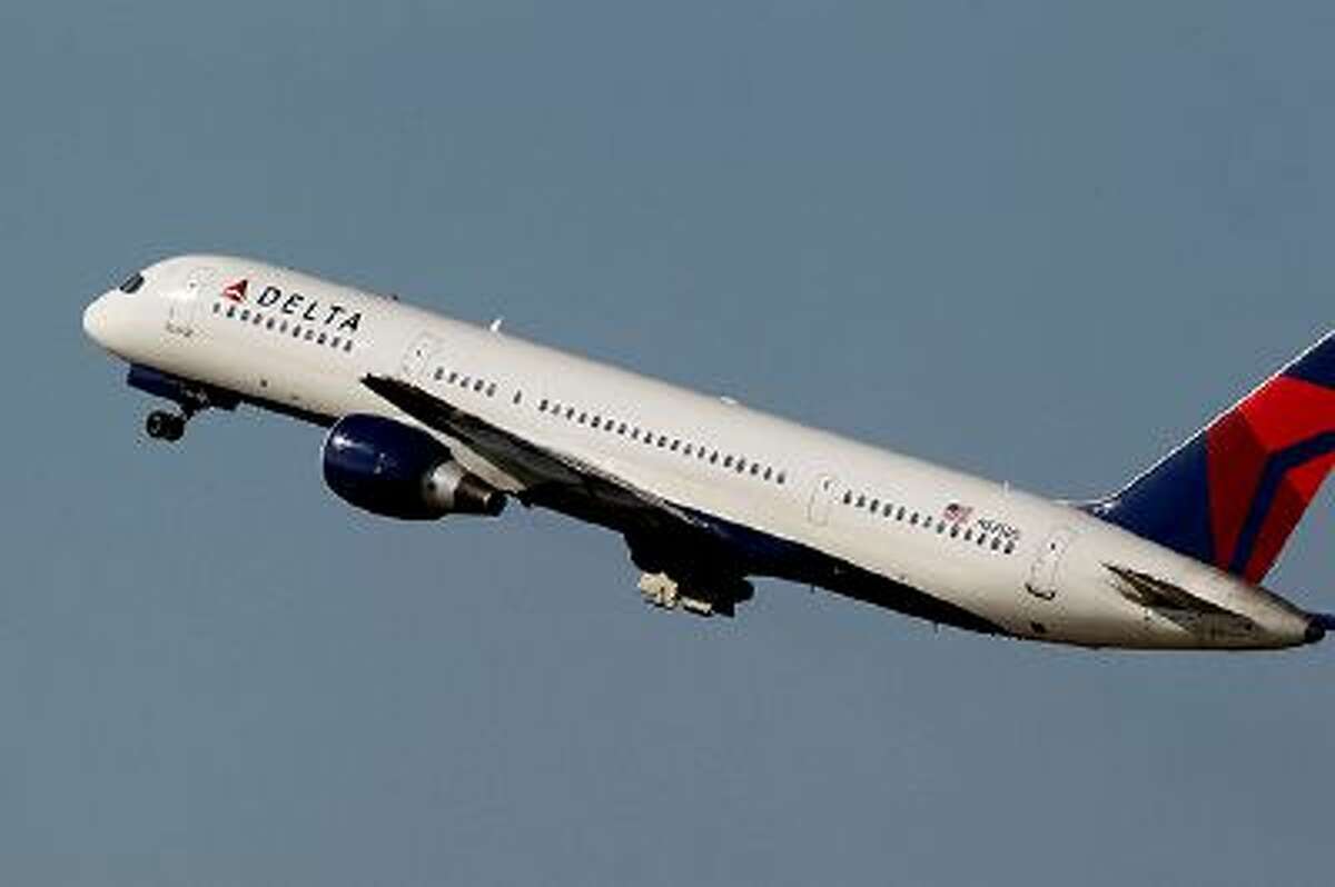 File-This photo taken Jan. 20, 2011, shows a Delta Airlines Boeing 757 taking off in Tampa, Fla. Delta Air Lines is making fundamental changes to its frequent flier program and will reward those who buy its priciest tickets, as opposed to those who fly the most miles. The airline said Wednesday, Feb. 26, 2014, that the 2015 SkyMiles program will better recognize frequent business travelers and leisure customers who buy premium fares. (AP Photo/Chris O'Meara, File)