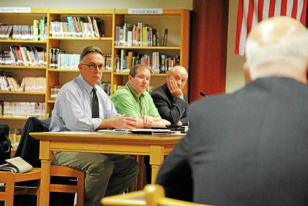 Paul Cavagnero, left, hears the conclusion of an investigation into his actions during a school improvement committee meeting, Sept. 11. D. Charles Stohler from Carmody & Torrance in Waterbury presents the investigation's findings.