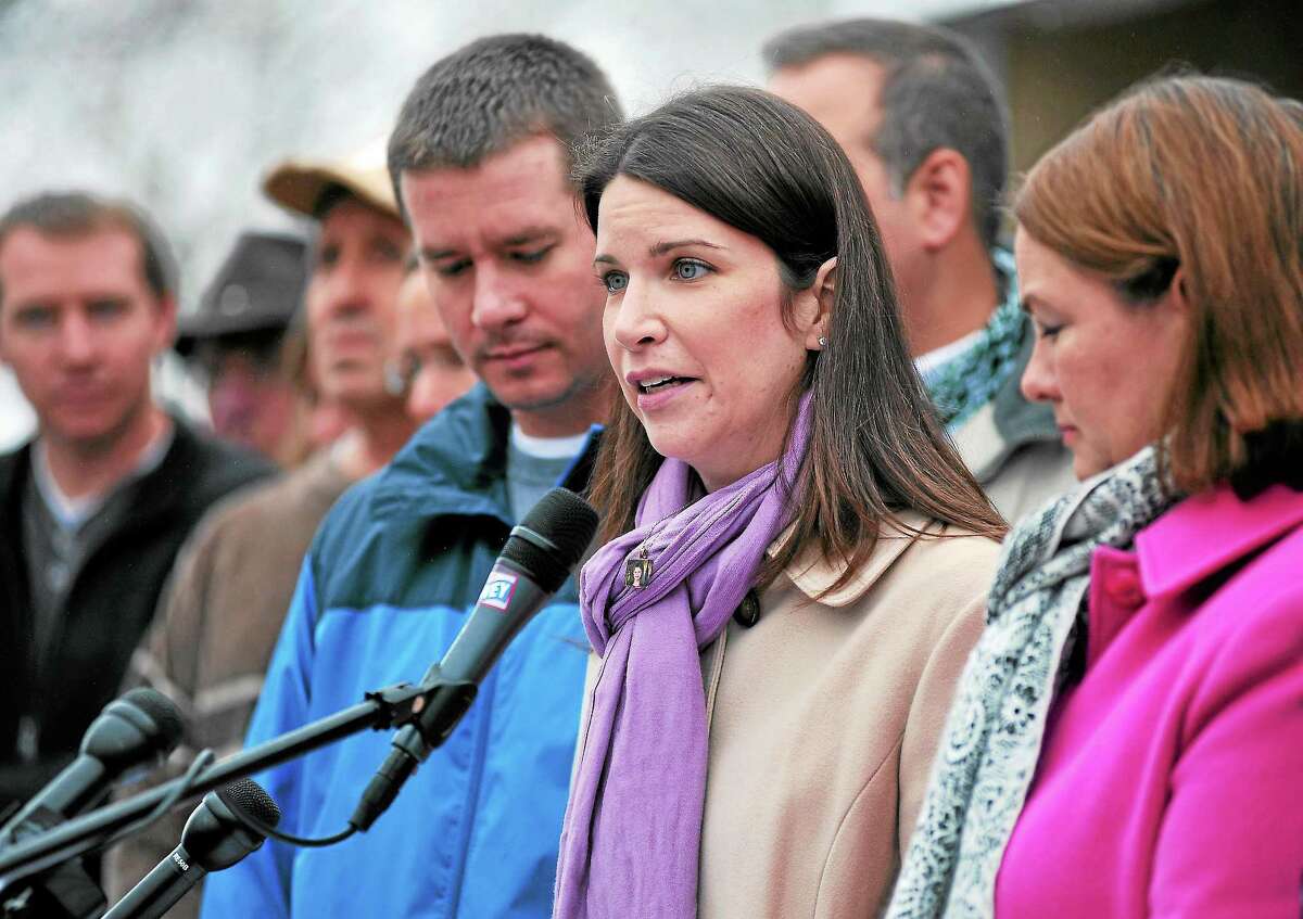 Krista Rekos, center, mother of slain Sandy Hook first-grader Jessica Rekos, speaks Monday in advance of the anniversary of the mass shooting at Sandy Hook Elementary School, surrounded by family members of the other victims.