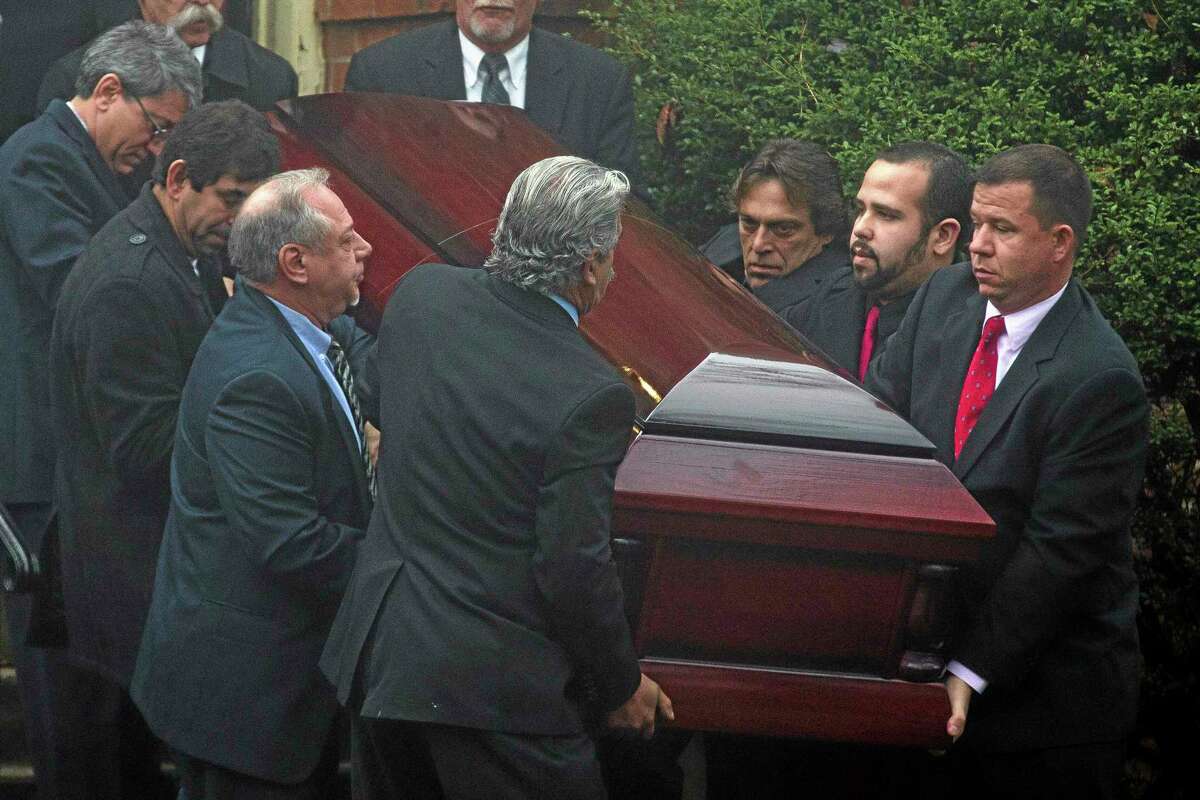 The casket of James Ferrari is carried out the Church of the Divine Love following funeral services, Thursday, Dec. 5, 2013, in Montrose, N.Y. Ferrari, 59, was killed along with three others when a speeding Metro-North Railroad train on the Hudson Line derailed in New York. (AP Photo/John Minchillo)