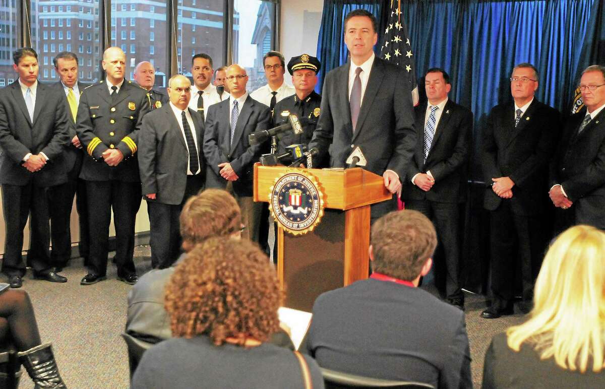 New FBI Director James Comey answers questions at a press conference during a visit to the New Haven FBI Field Office.