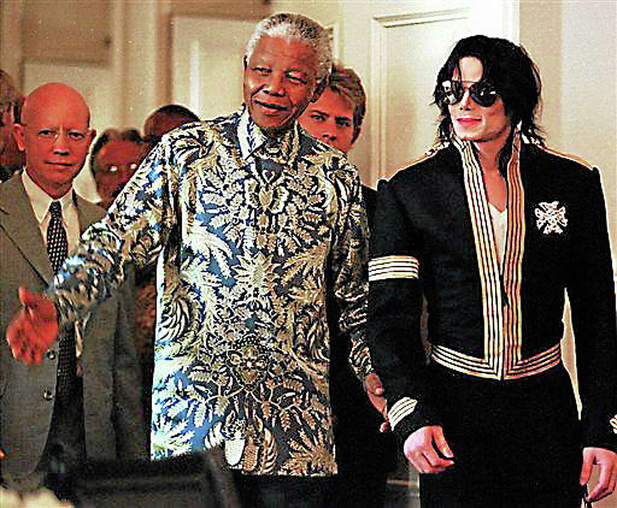 FILE - In this March 23, 1999 file photo, South African President Nelson Mandela, left, and American pop singer Michael Jackson arrive at a news conference in Cape Town, South Africa, where Jackson announced dates for two concerts with profits to go to various funds including the Nelson Mandela Children's Fund. South Africa's president Jacob Zuma says, Thursday, Dec. 5, 2013, that Mandela has died. He was 95. (AP Photo/Obed Zilwa, File)