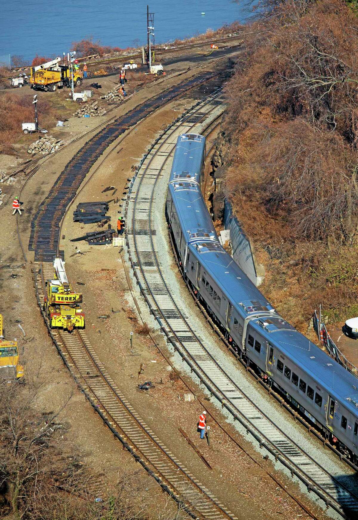 A Metro-North Railroad passenger train pulls out of the Spuyten Duyvil station in the Bronx borough of New York Wednesday, Dec. 4, 2013, as it passes the site of a fatal derailment that disrupted service on the Hudson Line of the railroad Sunday, Dec. 1. (AP Photo/Craig Ruttle)