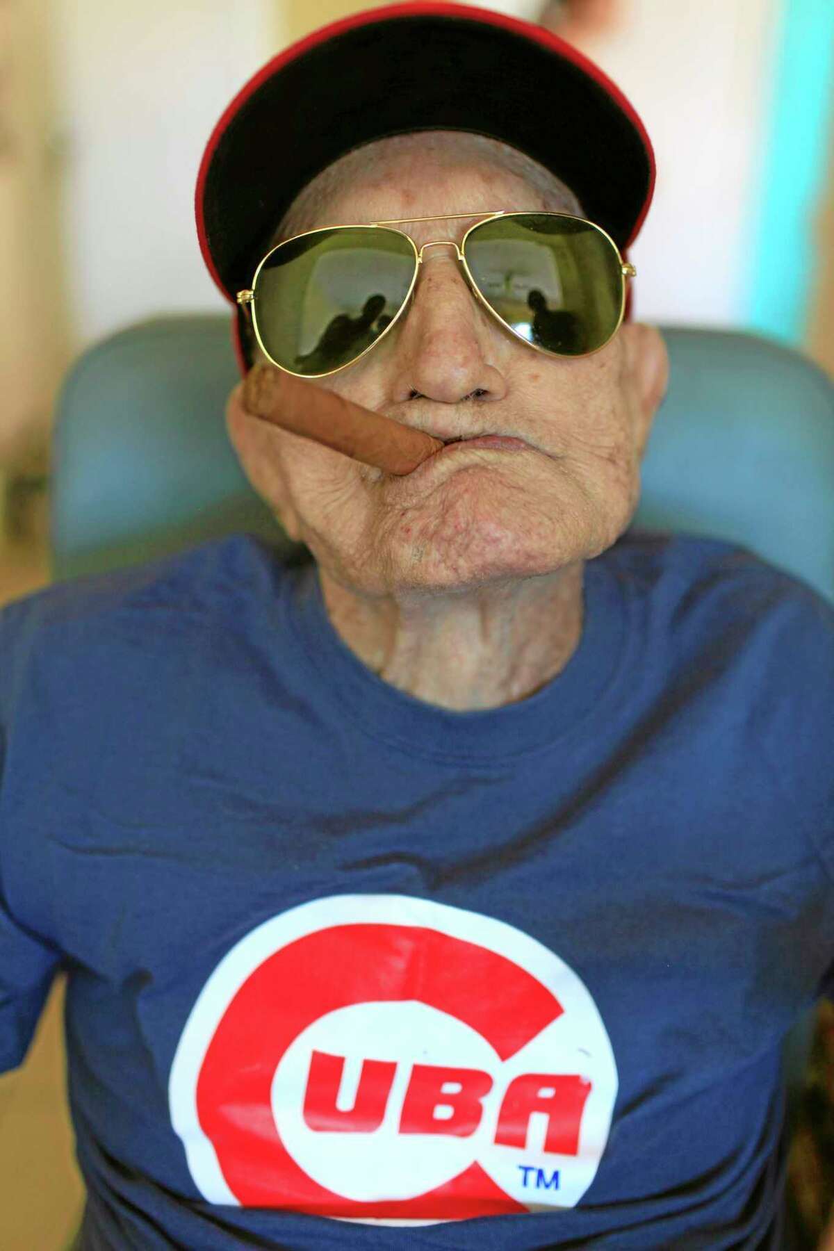In this April 25, 2013 file photo, Conrado Marrero, the world’s oldest living former Major League Baseball player, poses for a photo on his 102 birthday at his home in Havana, Cuba. Family members say Marrero died Wednesday in Havana, just two days short of his 103rd birthday. Marrero was a diminutive right-hander who went by the nickname “Connie” when he pitched for the Washington Senators in the 1950s.