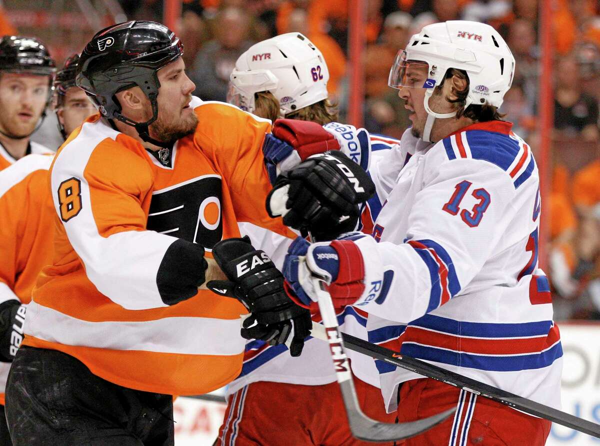 The Flyers’ Nicklas Grossmann, left, gets into a pushing match with the New York Rangers’ Daniel Carcillo during the first period of Game 3 of their first-round playoff series on Tuesday in Philadelphia.