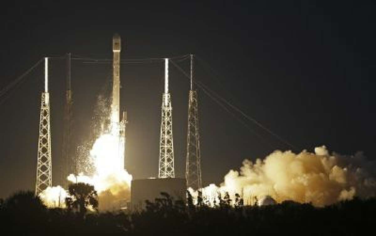 A Falcon 9 SpaceX rocket lifts off from Launch Complex 40 at the Cape Canaveral Air Force Station in Cape Canaveral, Fla., Tuesday, Dec. 3, 2013.