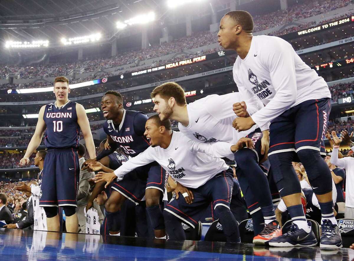 Connecticut players celebrate against Florida in the final moments of the NCAA Final Four tournament college basketball semifinal game Saturday, April 5, 2014, in Arlington, Texas. Connecticut won 63-53. (AP Photo/Eric Gay)