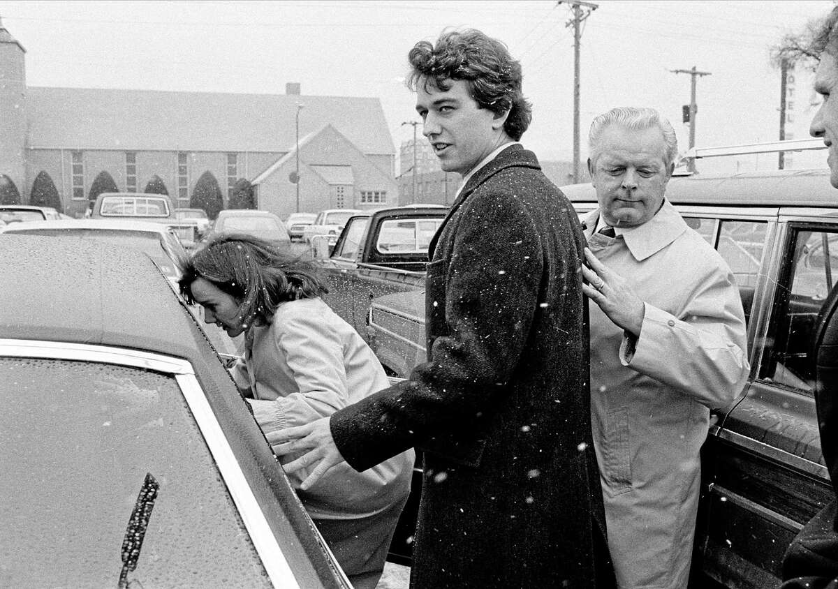 FILE - In this March 17, 1984 file photo, Robert Kennedy Jr. and his wife, Emily, get into a car as they are escorted by private investigator Don Wiley outside the courthouse in Rapid City, S.D. Kennedy received a suspended sentence and two years probation on his guilty plea to a charge of heroin possession. (AP Photo/Mark Elias)