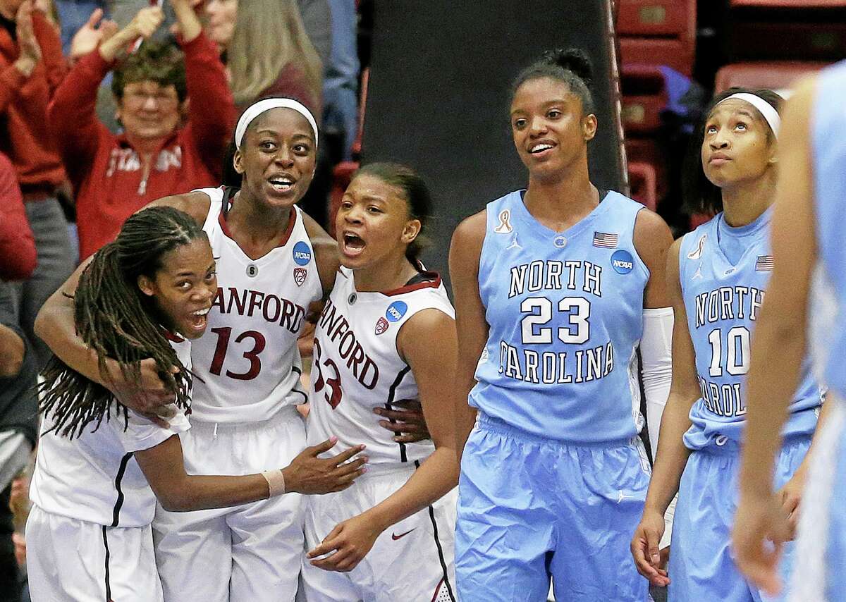 Stanford guard Lili Thompson, left, celebrates with forward Chiney Ogwumike (13) and guard Amber Orrange (33) during the second half of the Cardinal’s 74-65 regional final victory over North Carolina on Tuesday in Stanford, Calif.