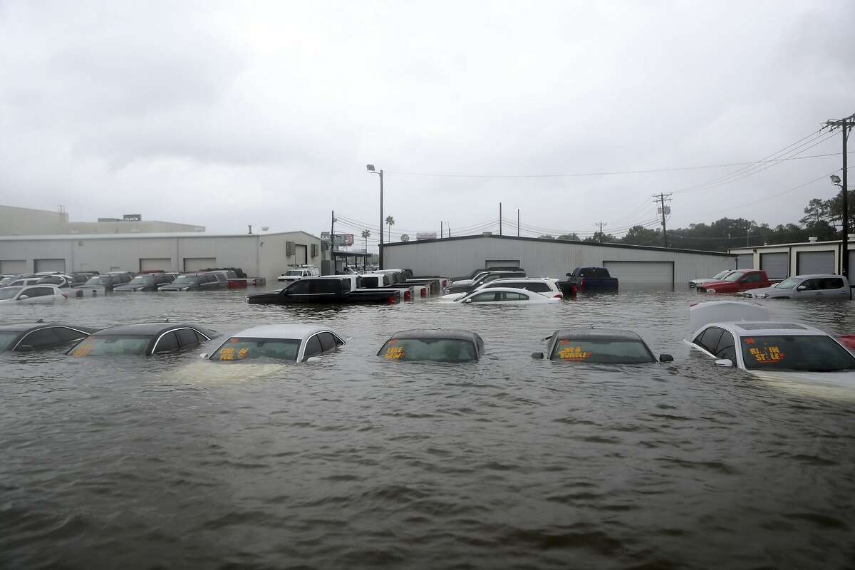 Vehicles are seen submerged at a dealership off Interstate 45 in Dickinson, Texas, Sunday, Aug. 27, 2017. (Kelsey Walling/The Galveston County Daily News via AP)