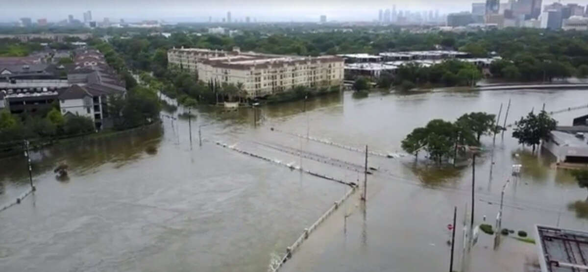 Drone footage captured in the West U area of Houston Sunday, Aug. 27, morning show rising waters in the Brays Bayou and streets filled with water during Tropical Storm Harvey.