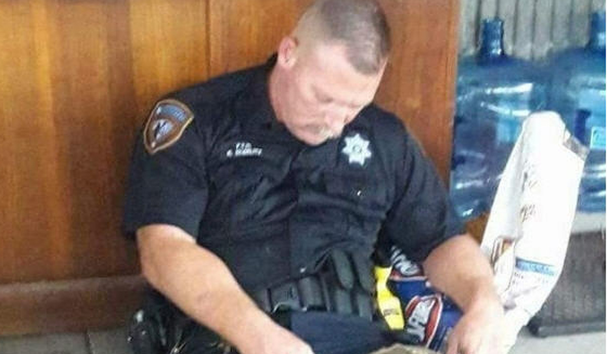 A photo of Harris County Deputy Sheriff Robert Goerlitz resting after helping Hurricane Harvey victims in Harris County on Aug. 27, 2017 has gone viral. See more images of flooding in Texas due to Hurricane Harvey. 