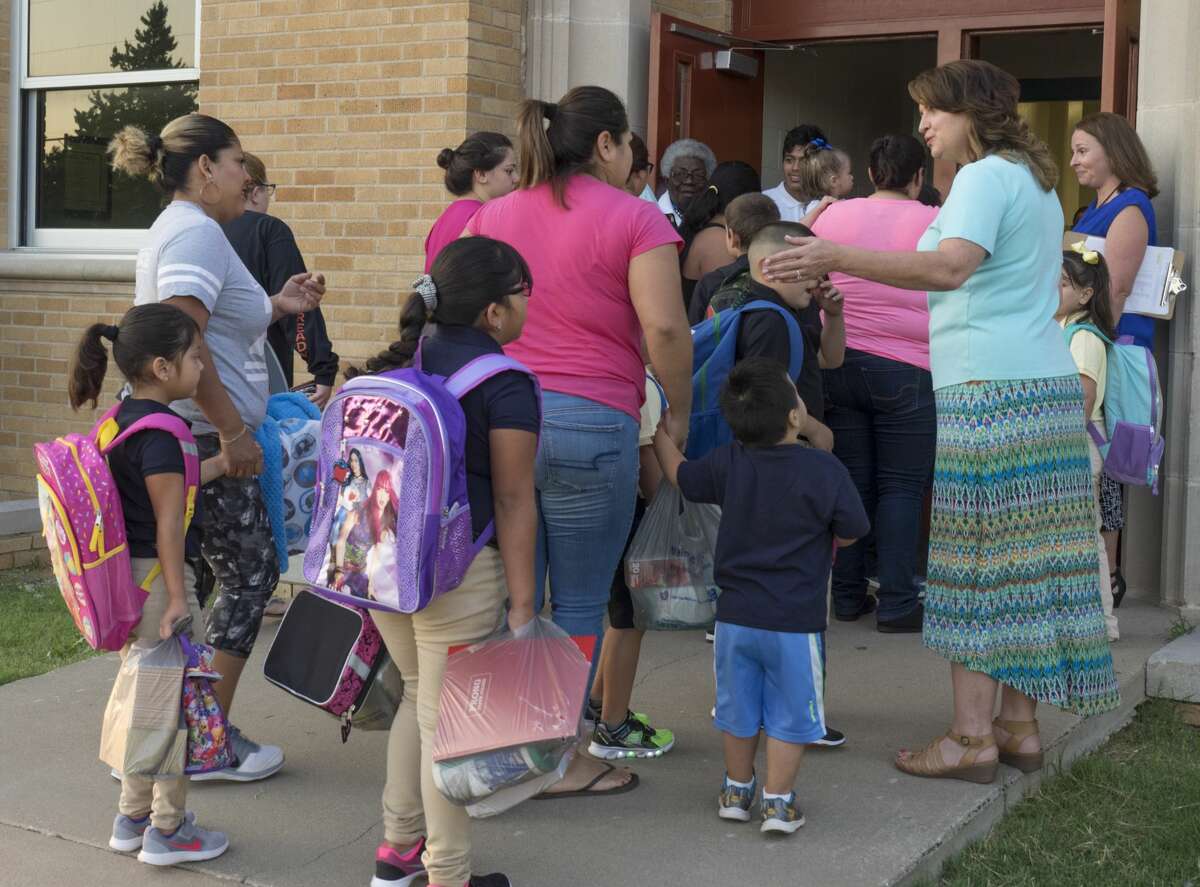 Teachers and administrators greet parents and students outside South Elementary 8/28/17 morning for the first day of school. Tim Fischer/Reporter-Telegram