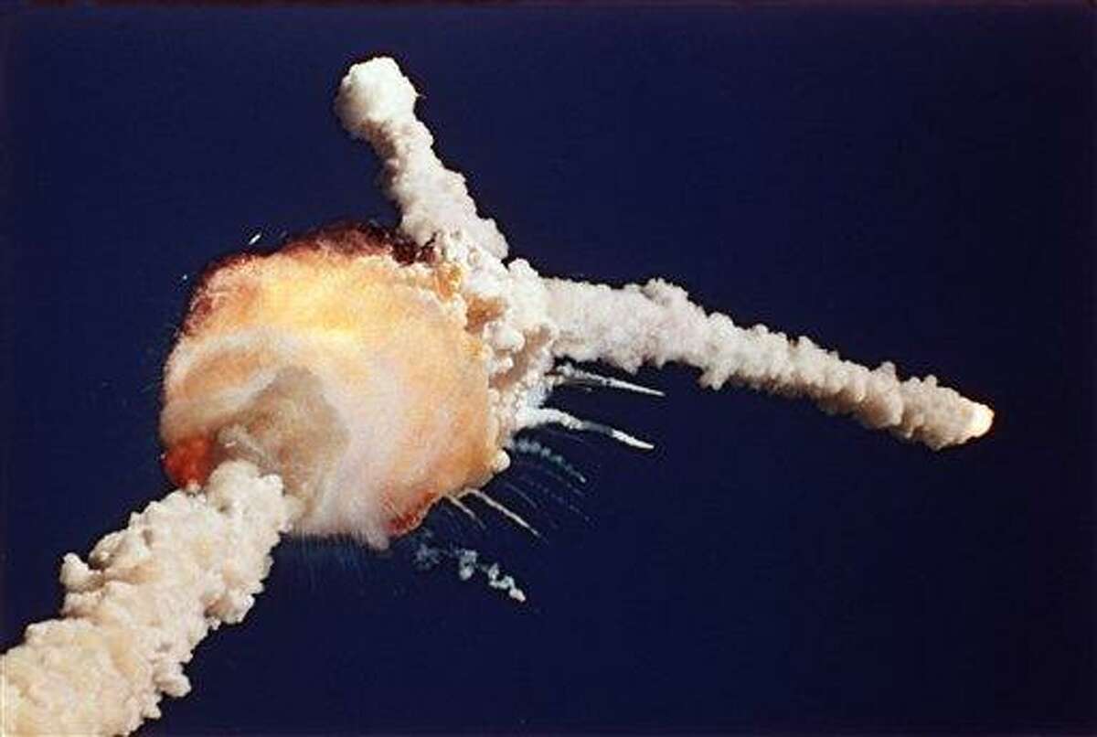 ** ADVANCE FOR USE FRIDAY, JAN. 28, 2011 AND THEREAFTER ** FILE - This Jan. 28, 1986 picture provided by NASA shows an unusual flame jutting from the side of a solid rocket booster on the space shuttle Challenger during its launch from the Kennedy Space Center in Cape Canaveral, Fla. A subsequent explosion killed its crew of seven. (AP Photo/NASA)