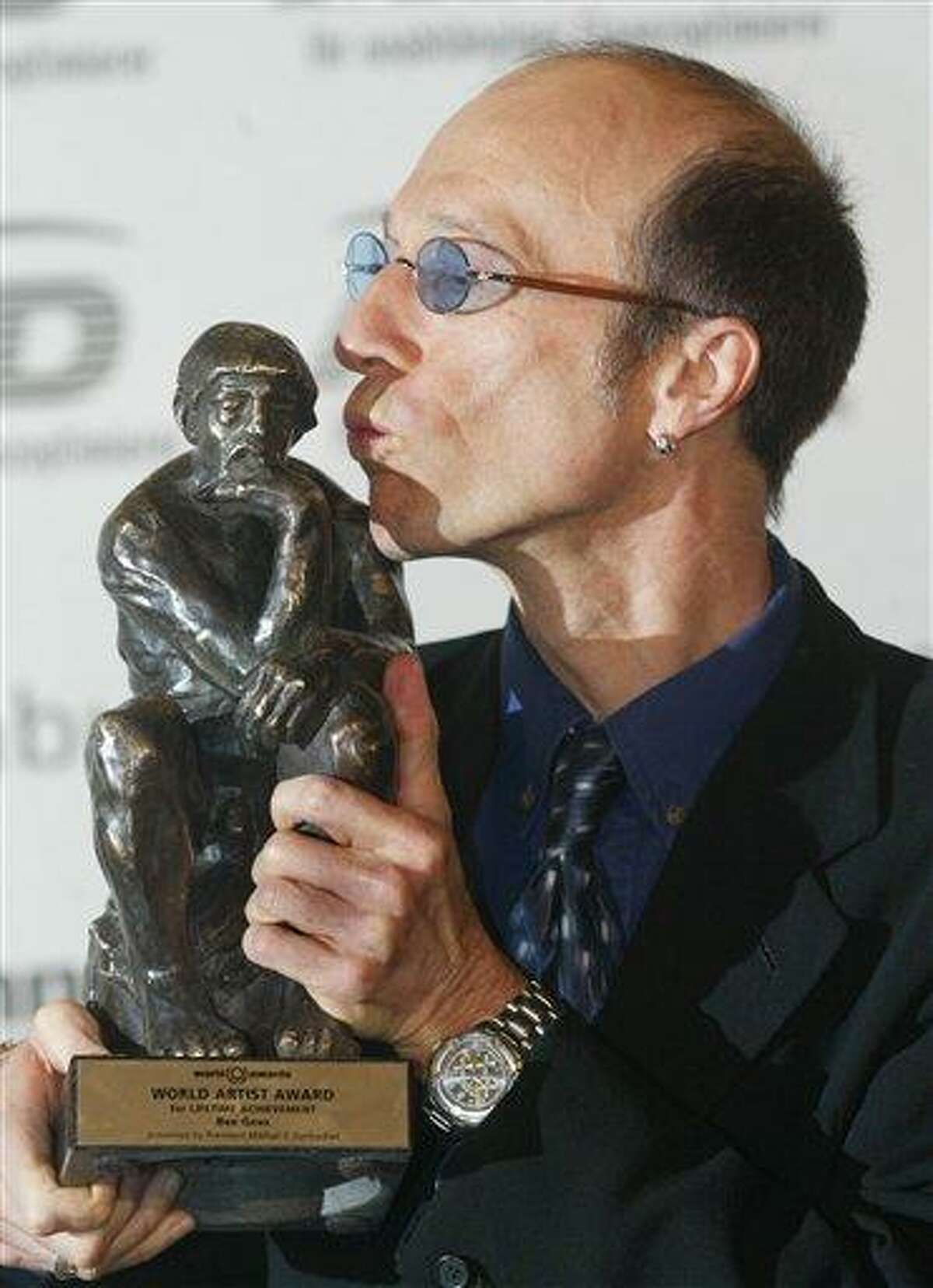 FILE - In this Oct. 22, 2003, file photo, musician Robin Gibb of The Bee Gees kisses his prize after he received it at the World Award ceremony in Hamburg, Germany. A representative said on Sunday, May 20, 2012, that Gibb has died at the age of 62. (AP Photo/Joerg Sarbach, File)