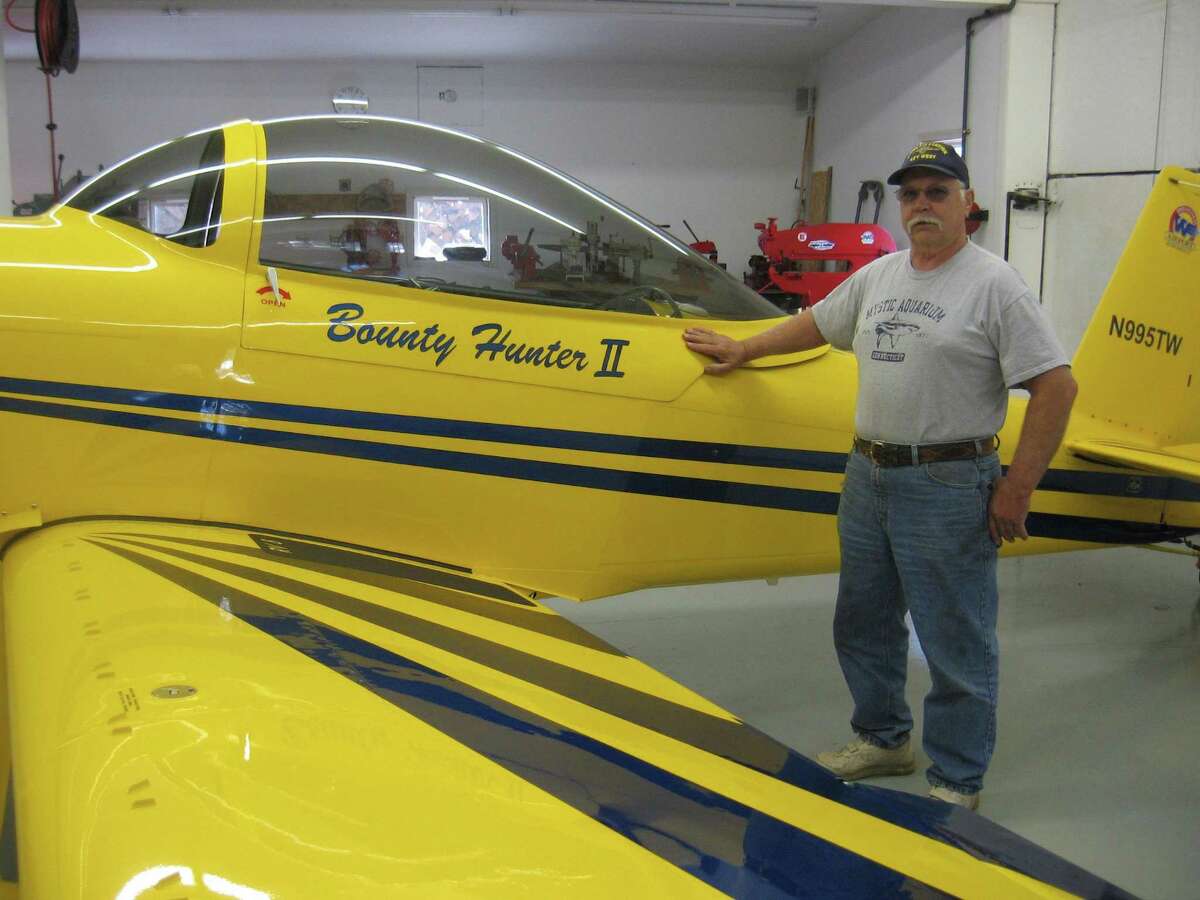 Tom Whelan with the Bounty Hunter II plane that he built a hangar at his private airport in Bethlehem.