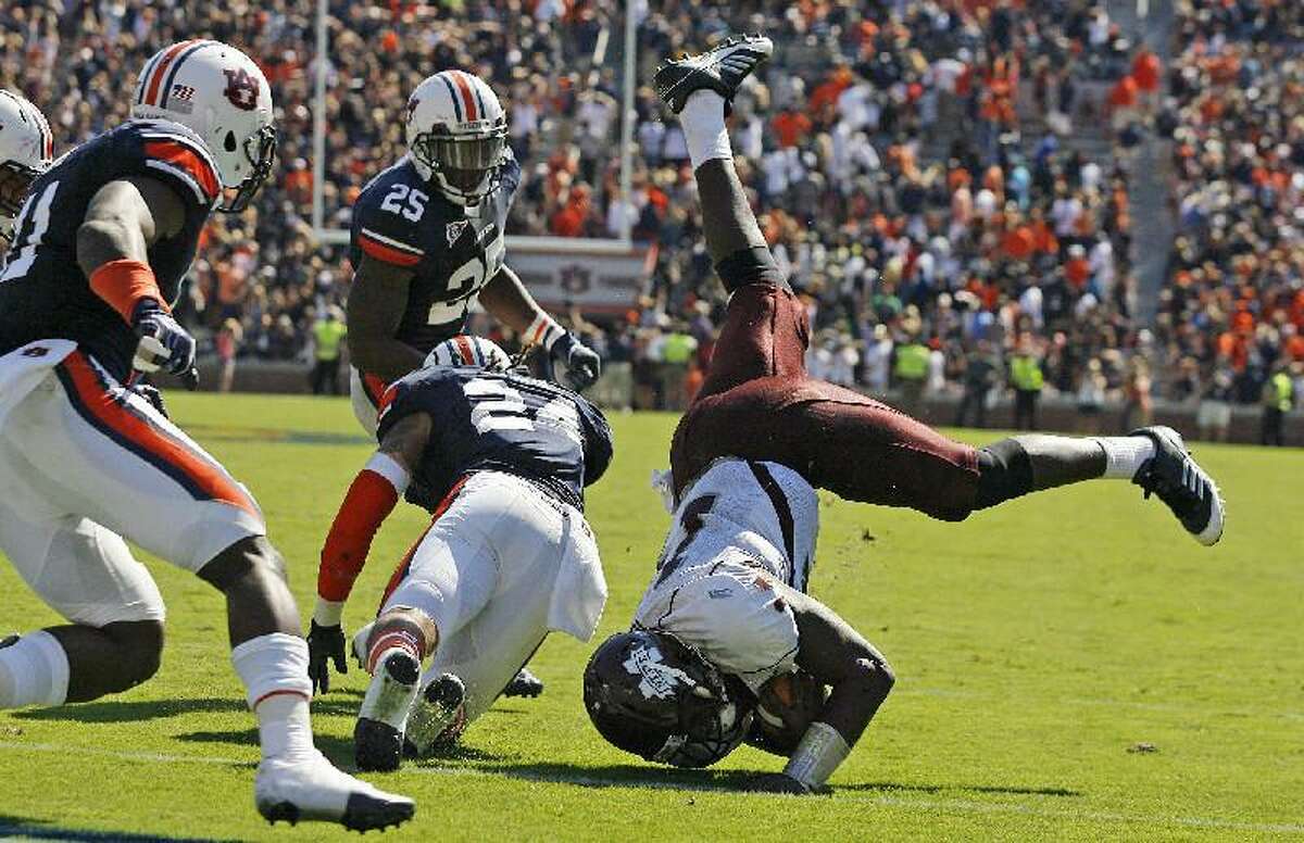 AP PHOTO/MIKE KITTRELL/MOBILE PRESS REGISTER Mississippi State quarterback Chris Relf (14) is upended short of the goal line on the final play of the game as Auburn defensive back Ryan Smith (24) defends during Saturday's game in Auburn, Ala.. Auburn won 41-34.