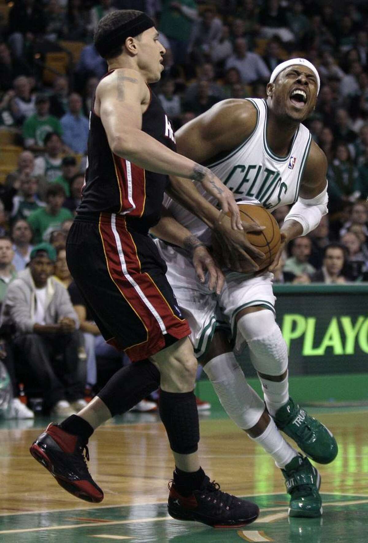 Boston Celtics forward Paul Pierce yells as he tries to get past Miami Heat guard Mike Bibby on a drive to the basket during the first quarter of Game 4 of a second-round NBA playoff basketball series, in Boston on Monday, May 9, 2011. (AP Photo/Charles Krupa)