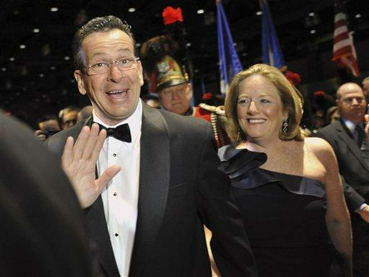 In this 2011 file photo, Gov. Daniel P. Malloy and his wife Cathy arrive at the Governor's Ball at the Connecticut Convention Center in Hartford. Cathy Malloy apologized Thursday for criticizing the media for scrutinizing elected officials to an extent that makes it harder to seek public office. Associated Press