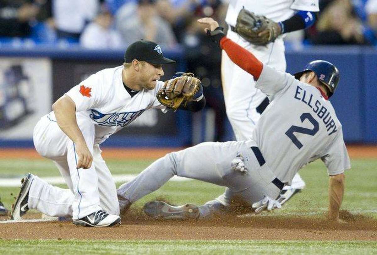 Boston Red Sox's Jacoby Ellsbury (2) slides safely under the tag of Toronto Blue Jays third baseman Brett Lawrie during the second inning of a baseball game in Toronto Tuesday, Sept. 6, 2011. (AP Photo/The Canadian Press, Darren Calabrese)