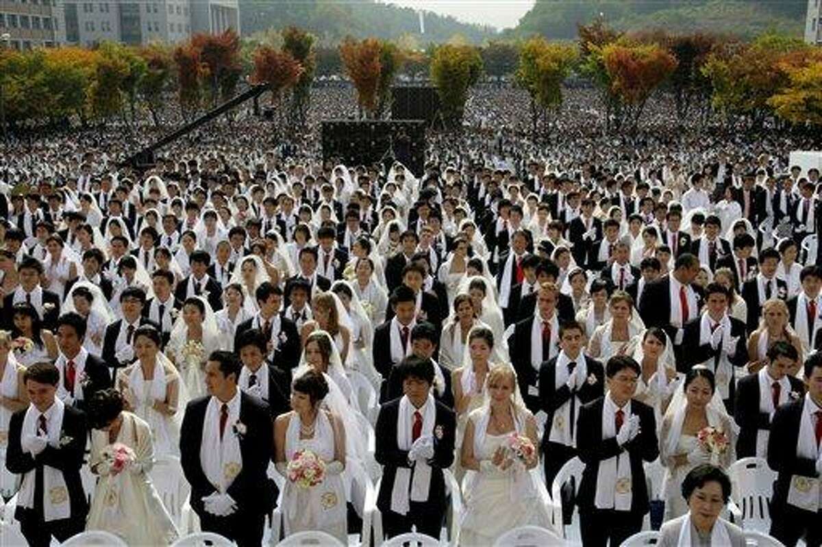 Couples from around the world participate in a mass wedding ceremony arranged by the Rev. Sun Myung Moon's Unification Church at Sun Moon University in Asan. AP Photo