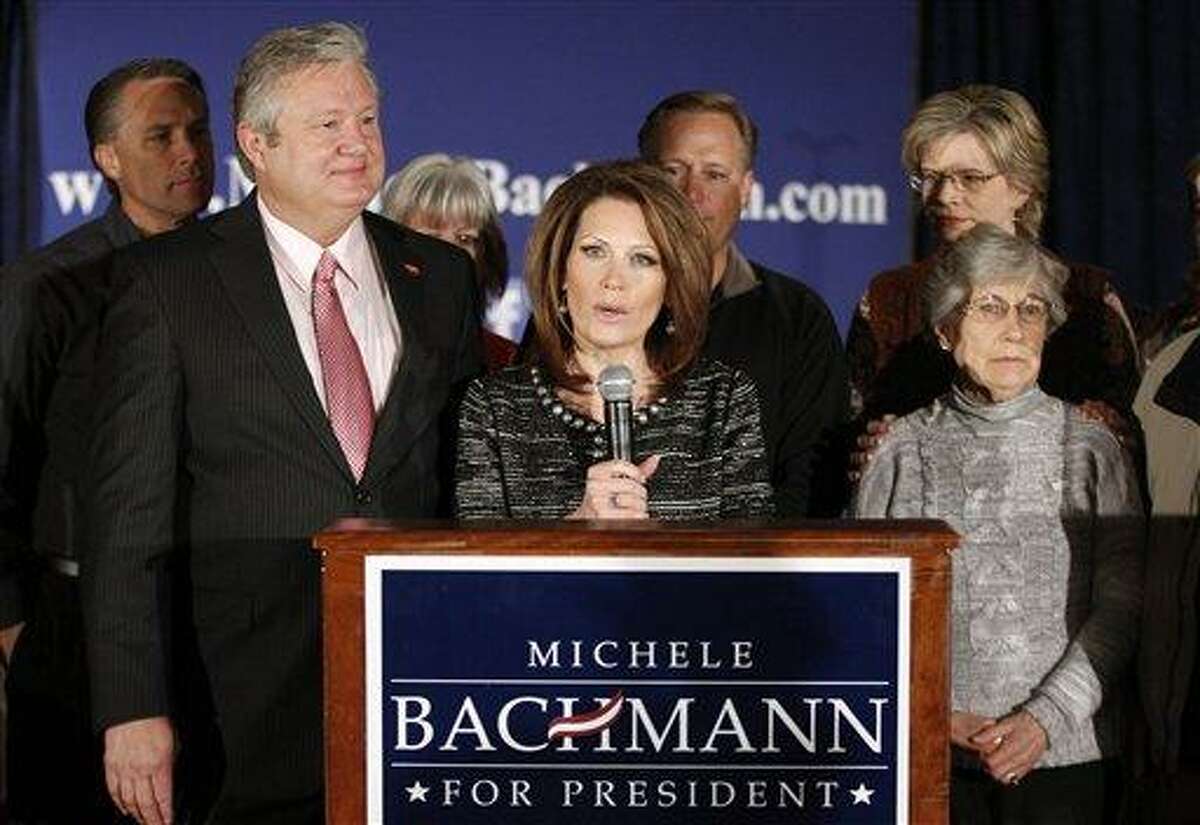 Rep. Michele Bachmann, R-Minn., center, joined by husband, Marcus, left, family and friends, announces that she will end her campaign for president Wednesday in West Des Moines, Iowa. Associated Press
