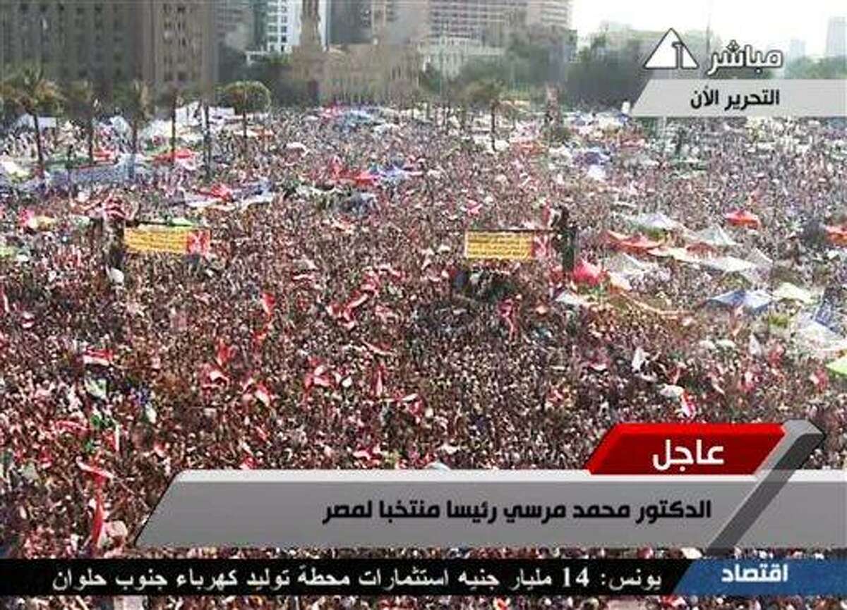 In this image taken from Egypt State TV, supporters of Muslim Brotherhood President Mohammed Morsi react Sunday to the announcement of his victory in Tahrir Square in Cairo, Egypt. Egypt's election commission has declared Morsi of the Muslim Brotherhood the winner of Egypt's first free elections by a narrow margin over Ahmed Shafiq, the last prime minister under deposed leader Hosni Mubarak. The commission said Morsi won with 51.7 percent of the vote versus 48.3 for Shafiq. Associated Press