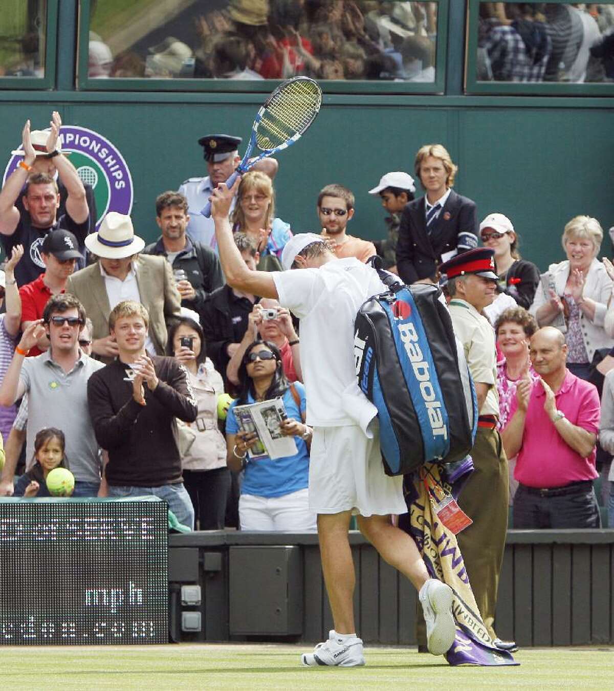 ASSOCIATED PRESS Andy Roddick waves goodbye as he leaves the court after being defeated by Spain's Feliciano Lopez at Wimbledon Friday.