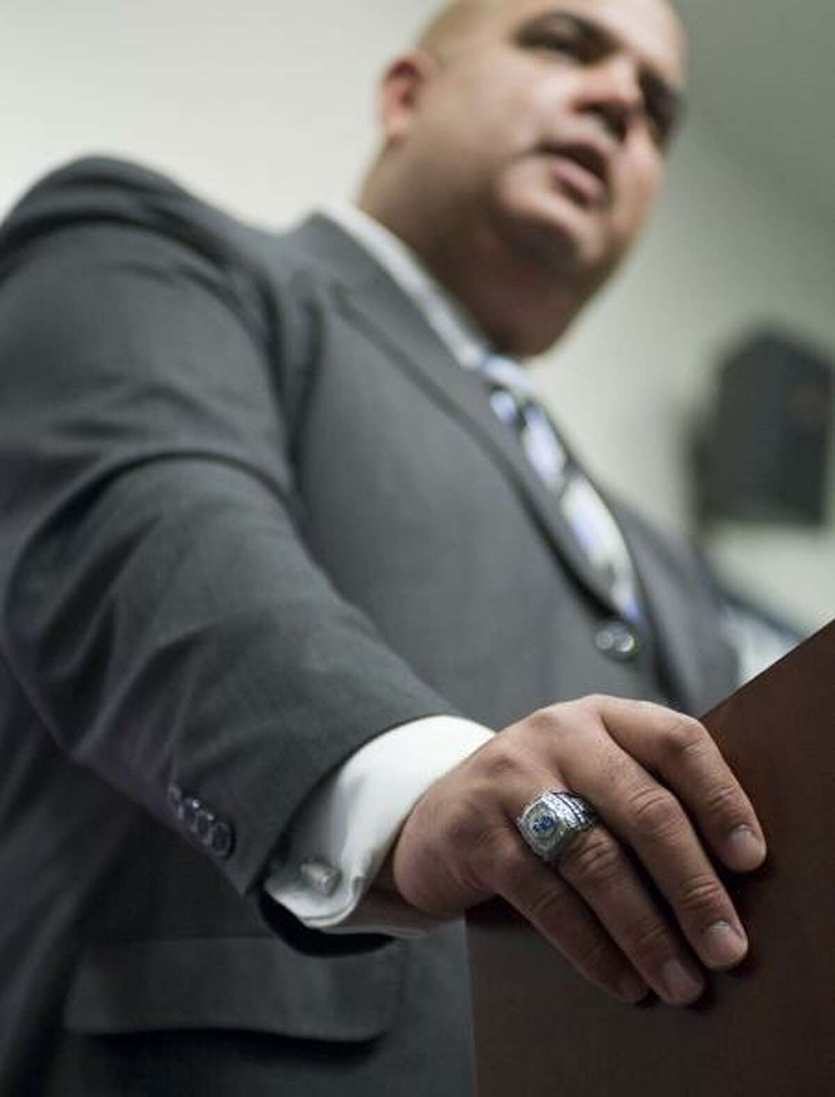 Former University at Buffalo Athletic Director Warde Manuel wears a championship ring from his former school as he is introduced as the new athletic director for the University of Connecticut at a news conference in Storrs, Conn., Monday, Feb. 13, 2012. (AP Photo/Jessica Hill)