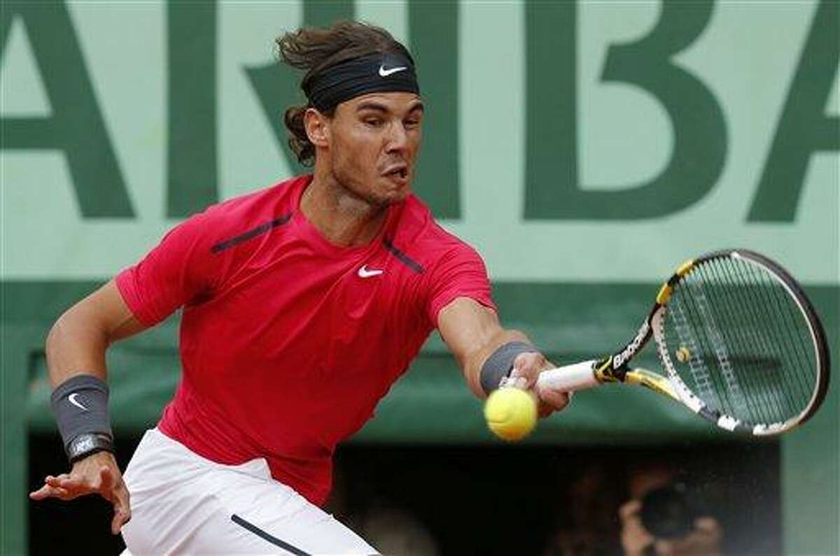 Spain's Rafael Nadal returns the ball to Serbia's Novak Djokovic during their men's final match in the French Open tennis tournament at the Roland Garros stadium Monday in Paris. Associated Press