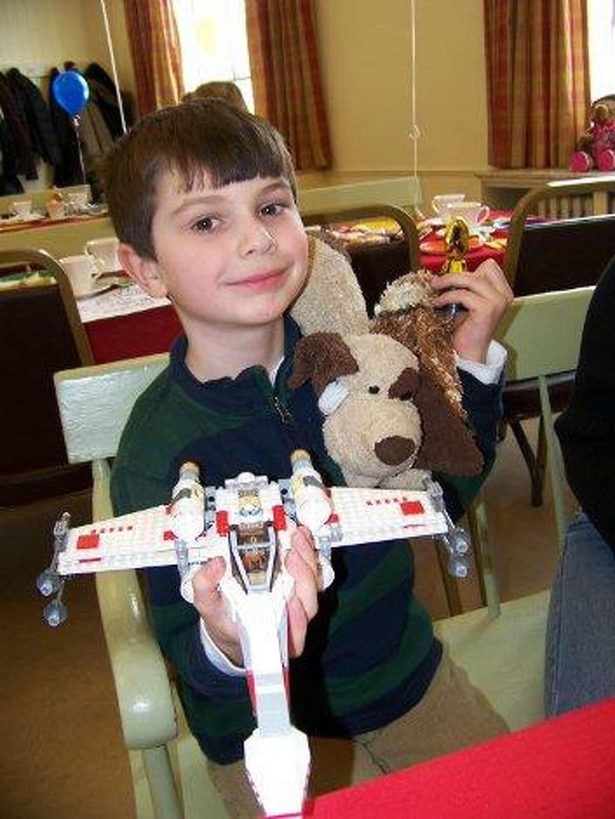 BARBARA THOMAS/Register Citizen Jacob Kuegler, 6-1/2, of Litchfield shows his trophy for winning the LEGO contest, along with his creation: a X-wing fighter from Star Wars.