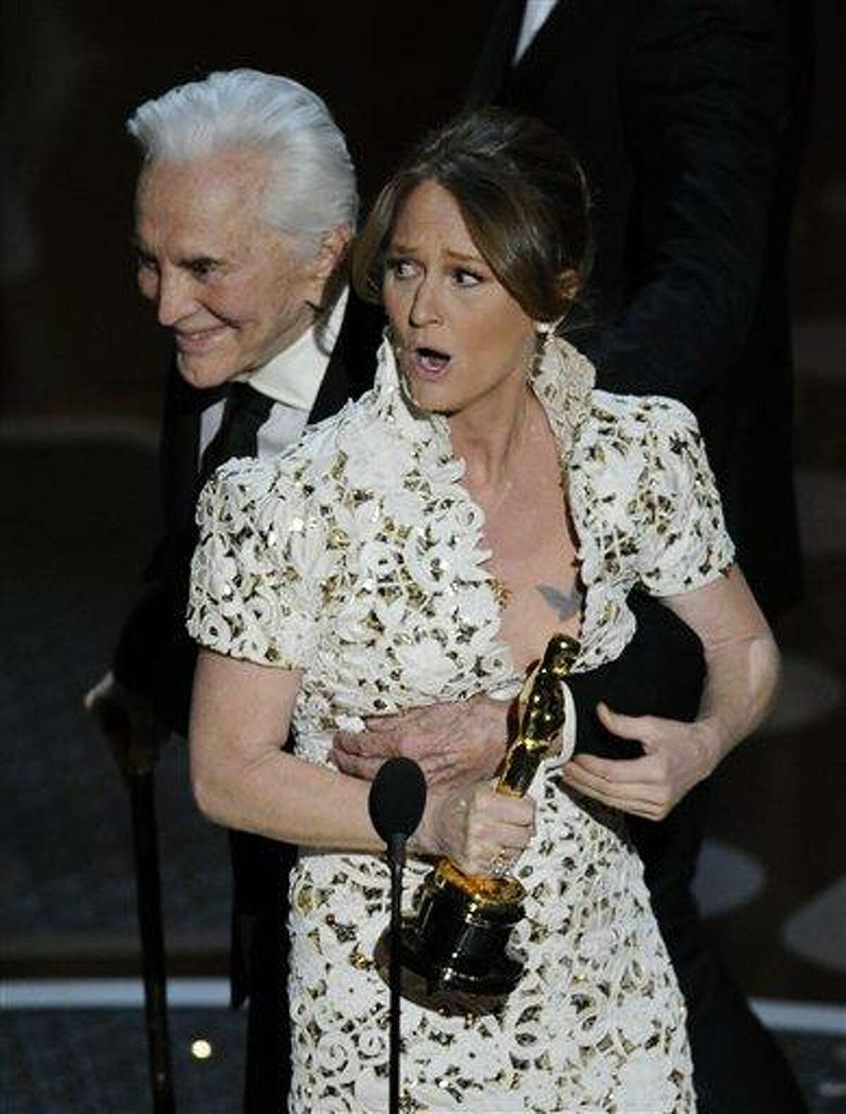 Melissa Leo gets a hug from Kirk Douglass as she accepts the Oscar for best actress in a supporting role for "The Fighter" at the 83rd Academy Awards on Sunday, Feb. 27, 2011, in the Hollywood section of Los Angeles. (AP Photo/Mark J. Terrill)