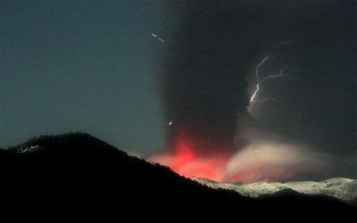 Lightning strikes over the Puyehue-Cordon Caulle volcano in Chile, seen from the international cross border way Cardenal Samore, in southern Chile, Sunday June 12, 2011. The volcano erupted June 4 after remaining dormant for decades. Chilean officials ordered most residents already evacuated from homes near the erupting volcano to stay in shelters and with family and friends Sunday due to the threat of deadly landslides. The ash spread across the Pacific, prompting authorities to suspend flights in Australia and New Zealand. (AP Photo/Alvaro Vidal)