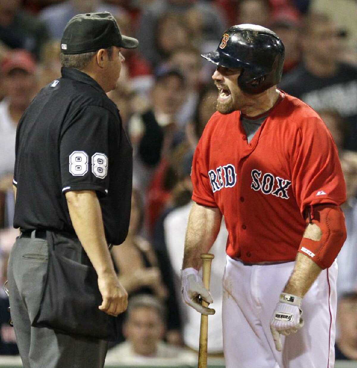 ASSOCIATED PRESS Boston Red Sox third baseman Kevin Youkilis argues with home plate umpire Doug Eddings after being called out looking with the bases loaded against the Washington Nationals in the sixth inning of Friday night's game at Fenway Park in Boston. Youkilis was ejected during the argument.