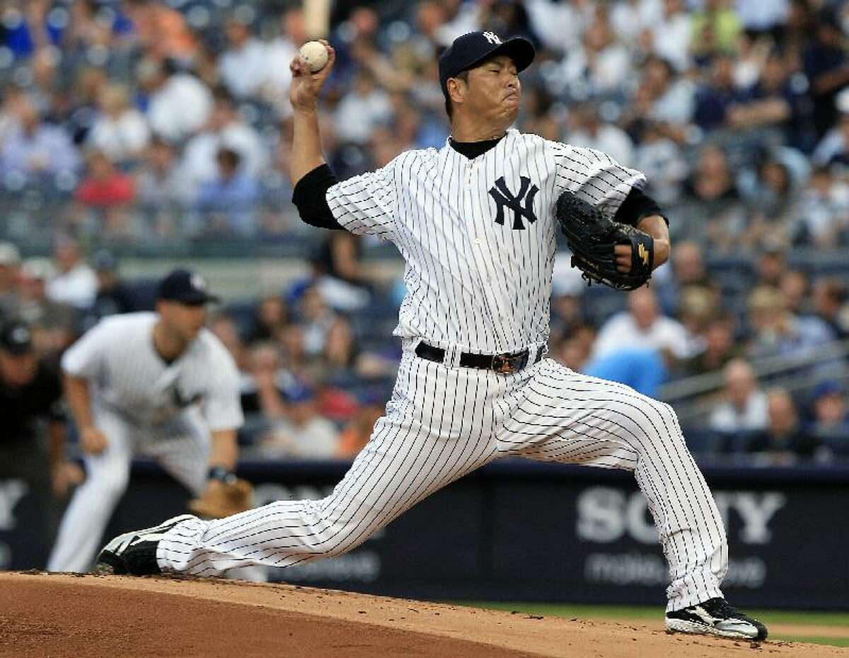 ASSOCIATED PRESS New York Yankees pitcher Hiroki Kuroda delivers during the first inning of an interleague game against the New York Mets on Friday at Yankee Stadium in New York. The Yankees beat the Mets 9-0.